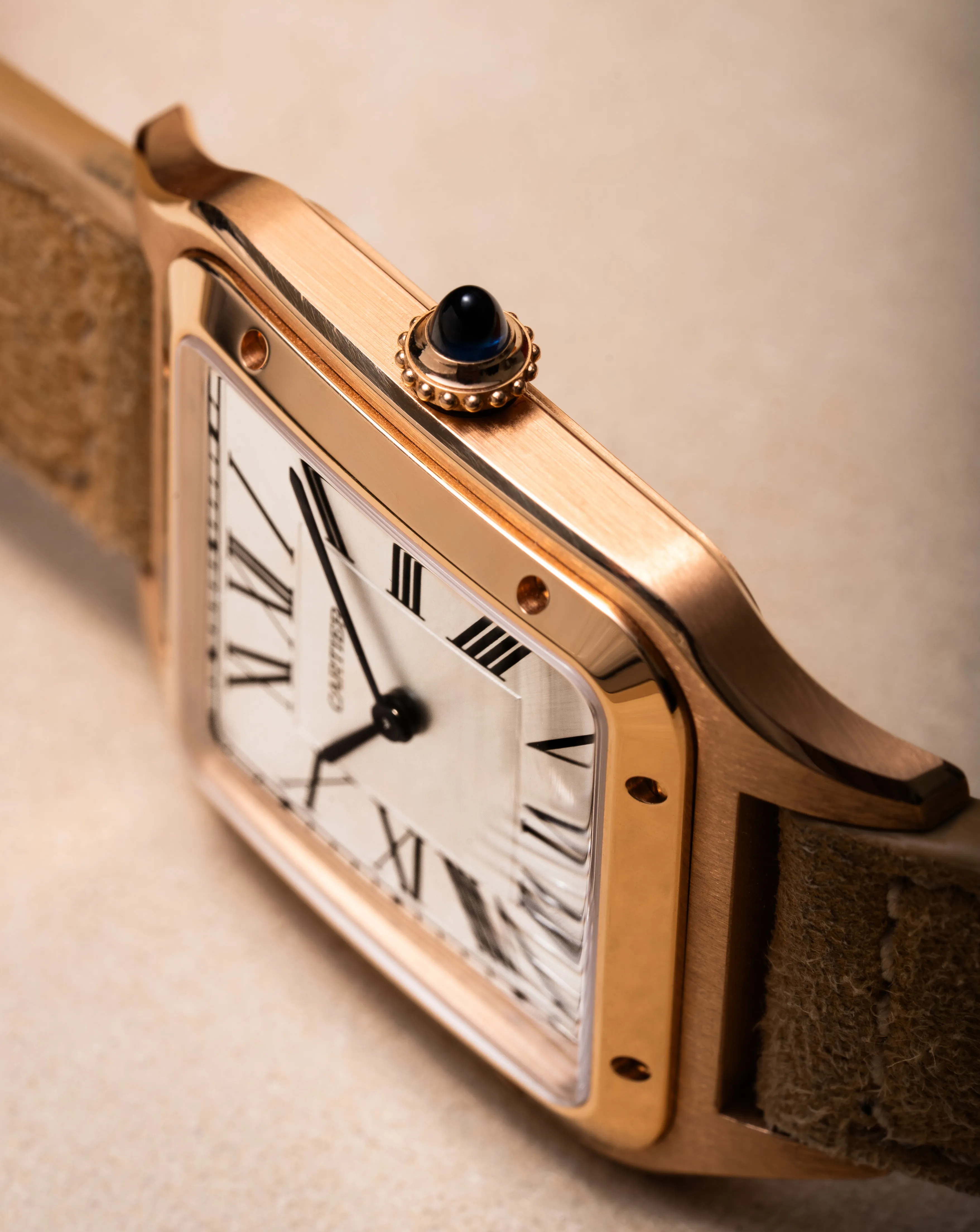 The Tank seated in its black Cartier presentation box with gold logo